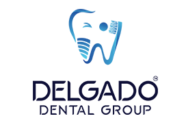 The image displays a logo consisting of a stylized letter  D  with a blue and white color scheme, accompanied by the text  DELADO DENTAL GROUP.